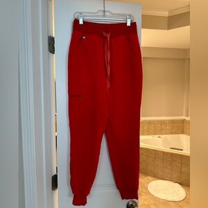 figs scrub bottoms in neon red